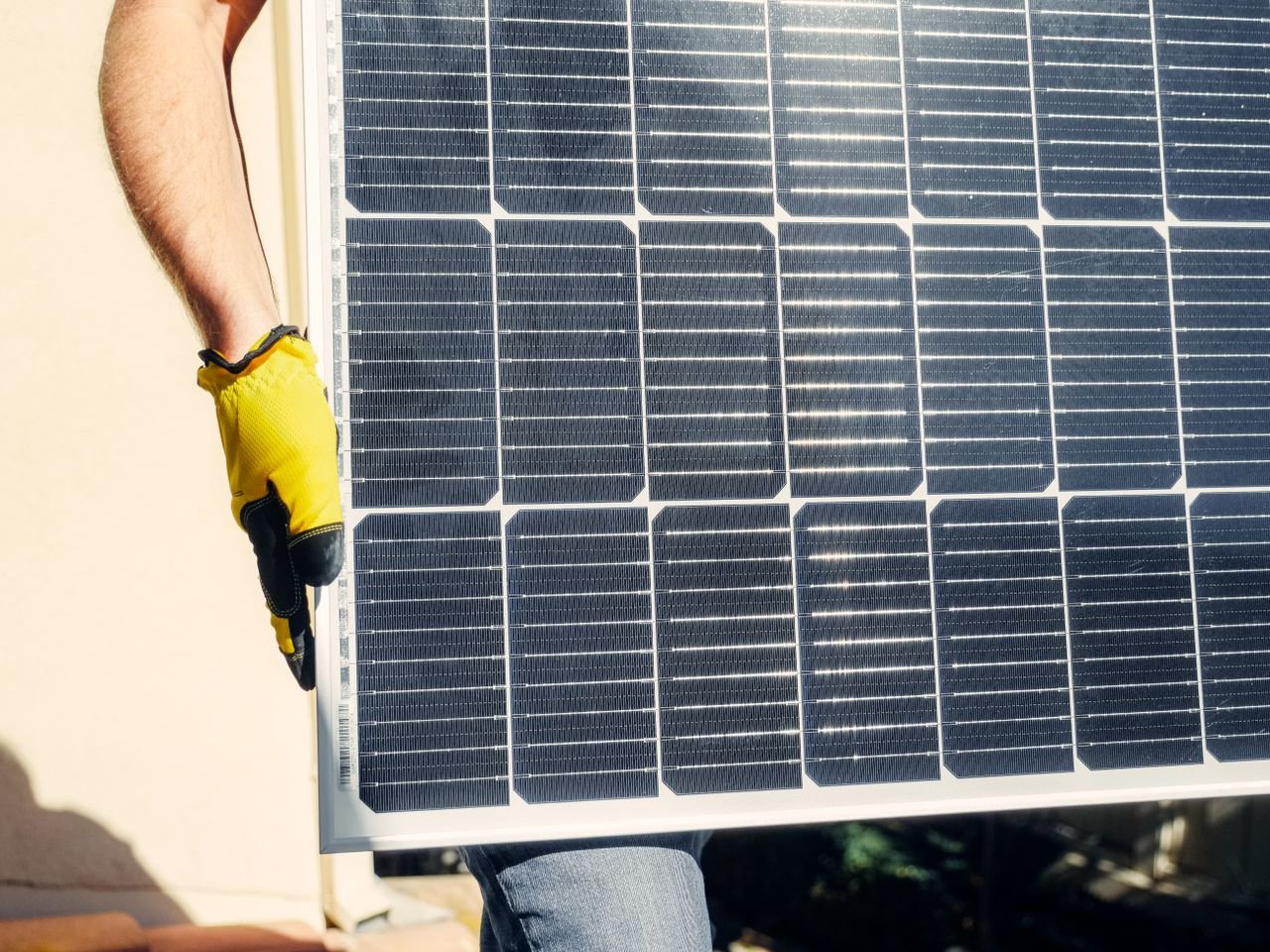 The Art of Drawing Readers In: Your attractive post title goes here Close-up of a person installing a solar panel outdoors under bright sunlight.