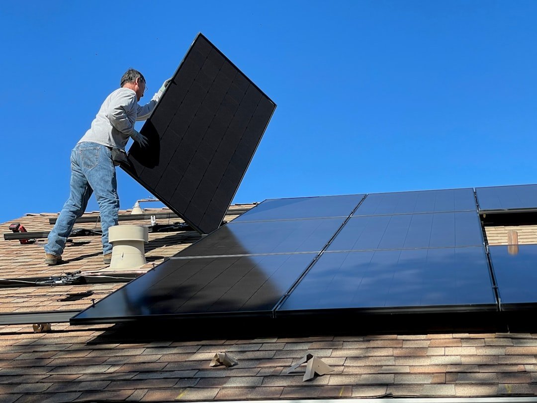 Crafting Captivating Headlines: Your awesome post title goes here Worker installing solar panels on a roof
